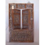 A large late 19th/early 20th century Chinese hardwood wall plaque, with two hinged doors, having