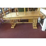 A Biedermeier maple and beech wood desk, part ebonised, with three drawers, raised on turned legs,