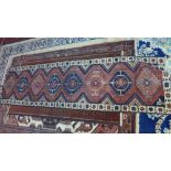 A North West Persian Hertz runner, 283cm X 73cm. A repeating stylized geometrical motifs on a