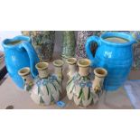 A pair of cyan glazed jugs together with two Persians flasks