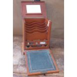 An early 20th century compartmentalised letter rack with integrated leather top writing slope