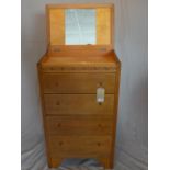 An early 20th century oak pedestal dressing chest, with mirrored back hinged lid, above five