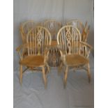 A set of six early 20th century pine wheel back dining chairs, to include two carvers