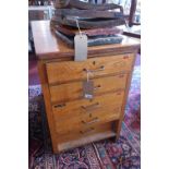 An early 20th century oak double sided pedestal chest, with ten drawers, raised on plinth base, H.84