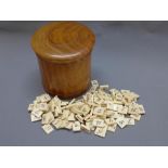 A quantity of 19th century ivory numbered gaming counters within a satinwood tea caddy