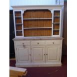 A mid 20th century white painted pine dresser, with superstructure, over three drawers and three