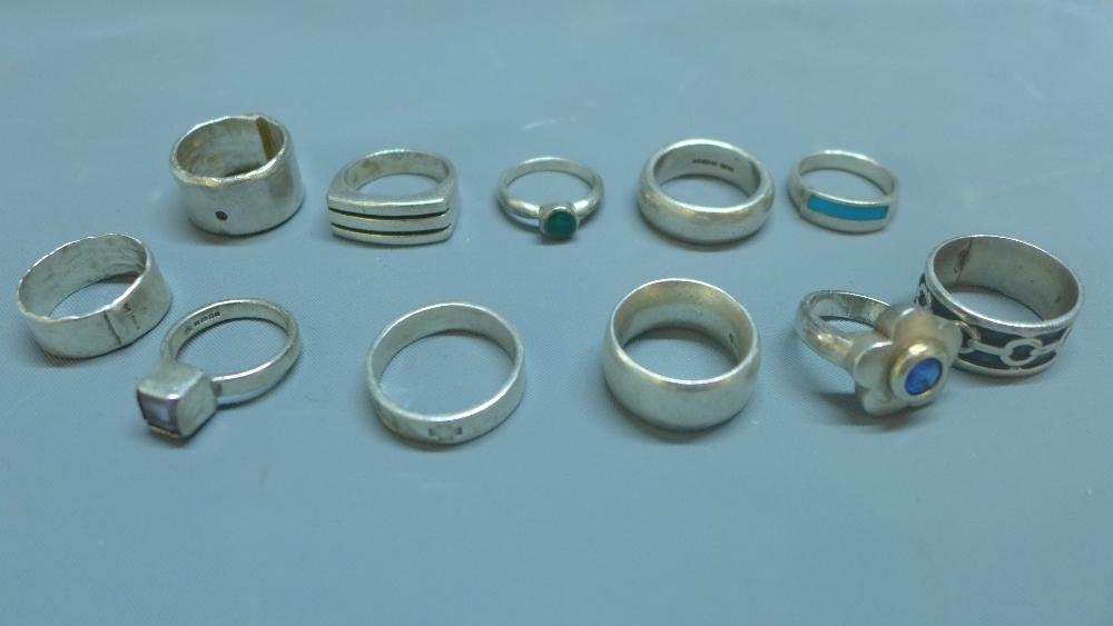 A collection of eleven silver and white metal rings, to include a silver ring with inset amethyst,