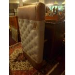 A large contemporary stool, with stone linen and tan leather upholstery, raised on turned legs, H.40