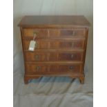 A Georgian style mahogany chest, with four graduating drawers, raised on bracket feet, bearing label