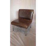 A 20th century brown leather chair, raised on chrome legs
