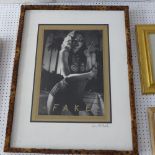 A giclee print of a pin up girl, 'Fake', bearing signature, in faux leopard skin frame, 58 x 42cm