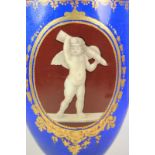 A late 19th century Coalport porcelain vase, decorated with vignettes of cherubs on a brown