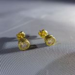 A pair of 18ct yellow gold and diamond inset earrings, round cut diamond approx. 0.5cts in total, SI