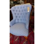 A Victorian style spoon back armchair, with blue floral button back upholstery, raised on cabriole