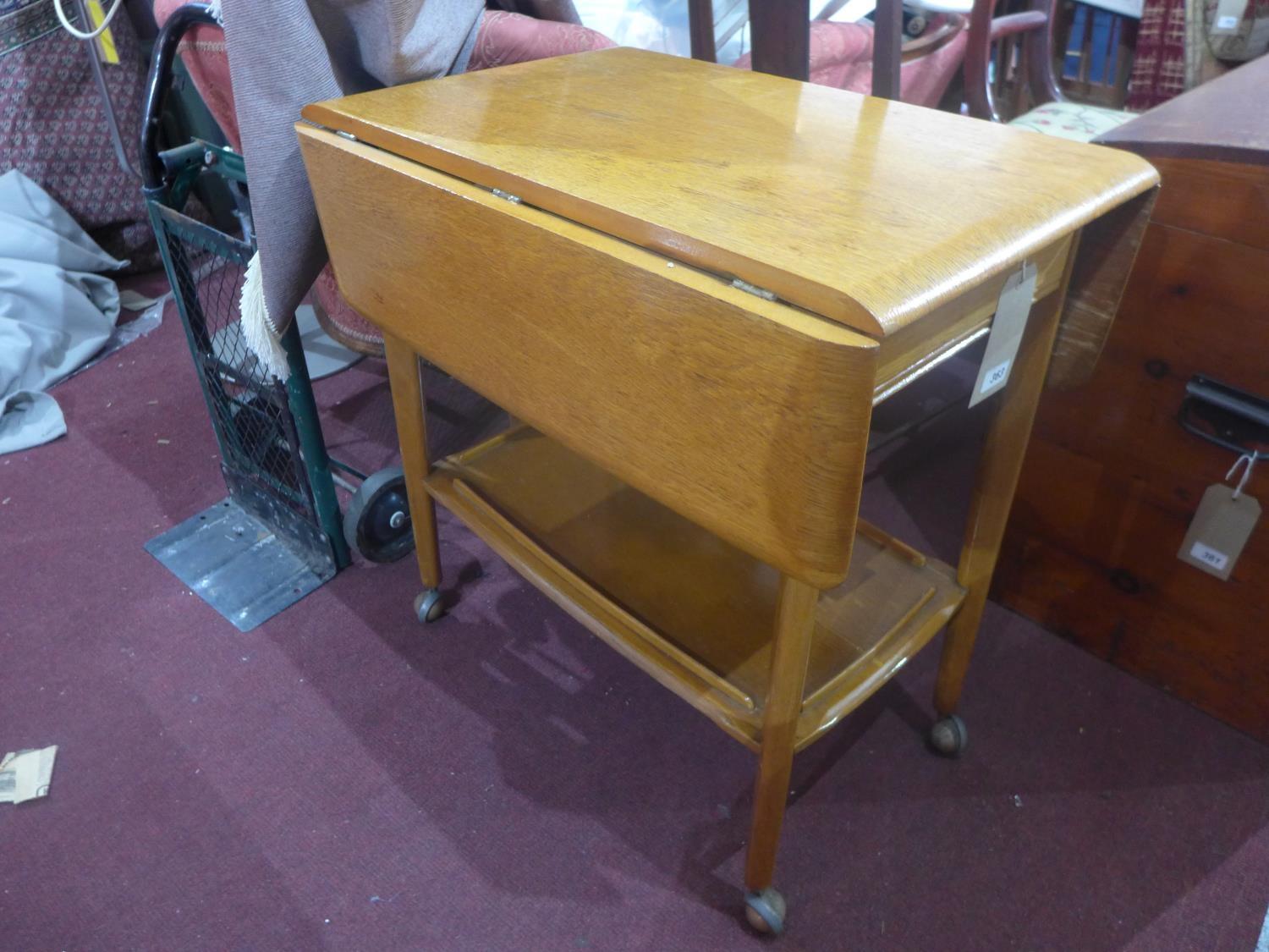 A mid 20th century oak trolley, with single end drawer, raised on castors