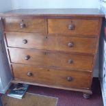A mahogany chest of two short over three long drawers, raised on turned legs, H.106 W.108 D.50cm,