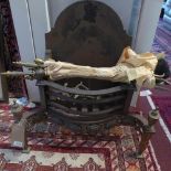 A late 19th century cast iron fireplace, with fire dogs, tongs, brush and pokers