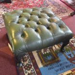 A Victorian style foot stool, with green leather button down upholstery, raised on cabriole legs