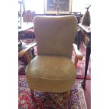 A 1950's walnut cocktail chair, with green velour upholstery