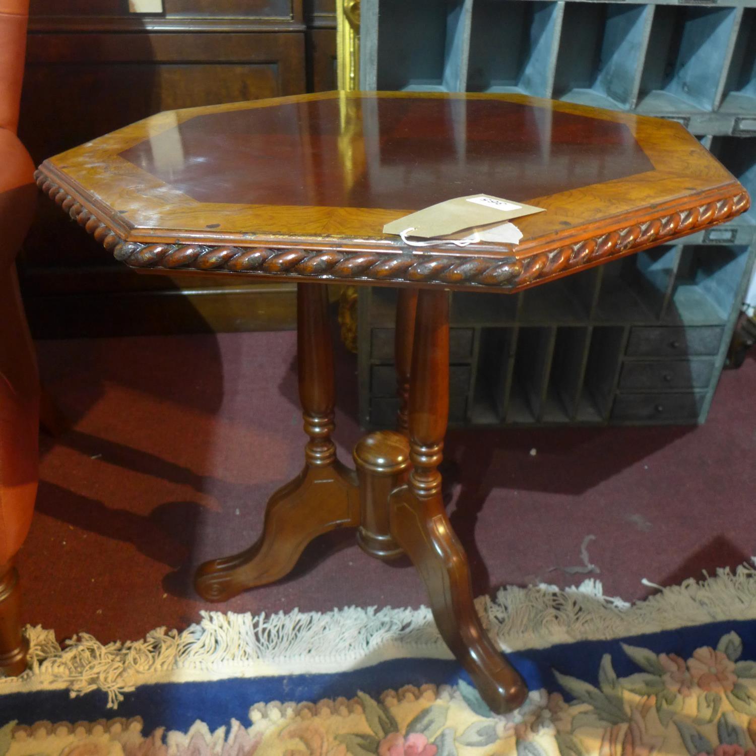 A 20th century mahogany octagonal table, with oak crossbanding