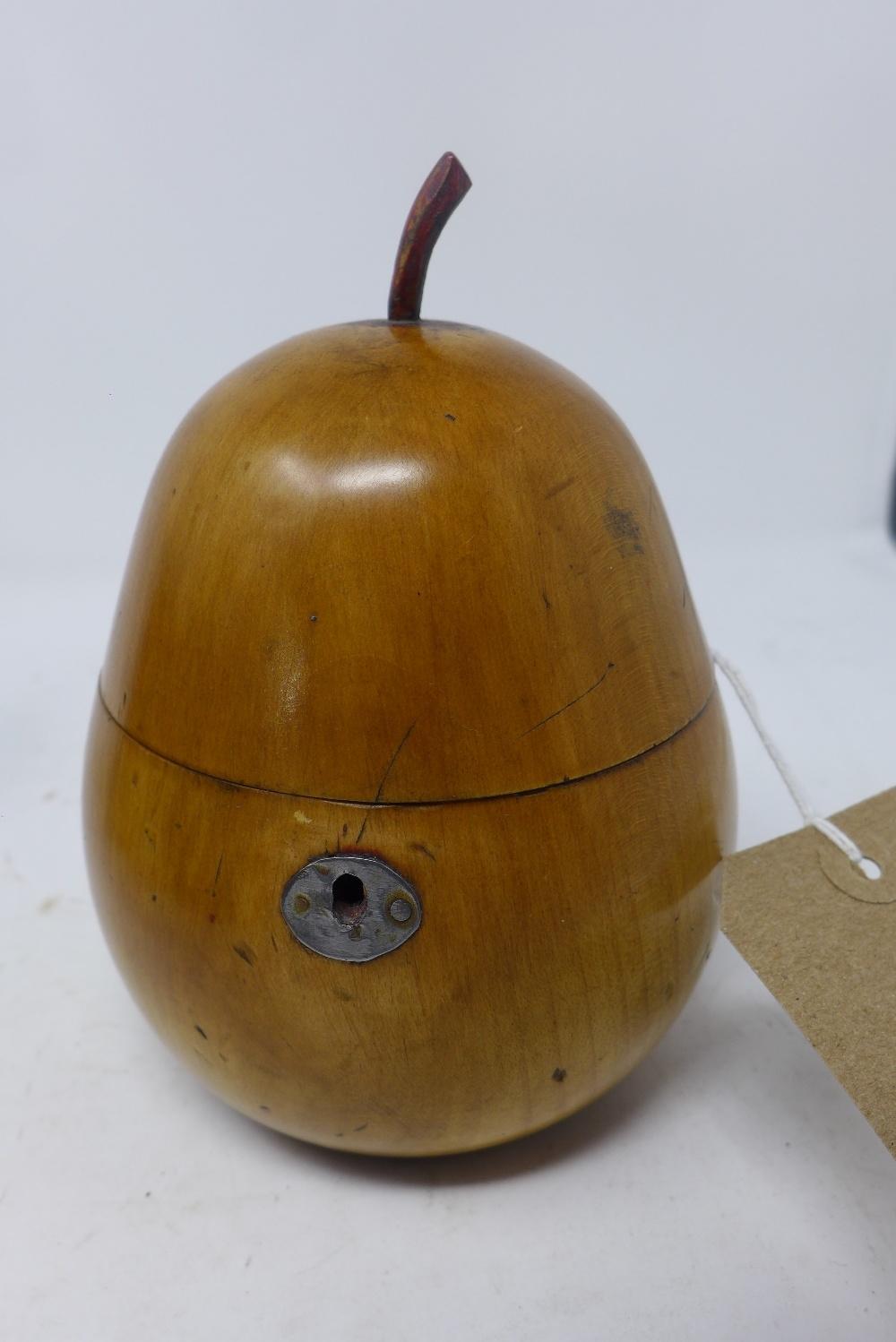 An early 20th century Georgian style walnut tea caddy, in the form of a pear, H.15cm