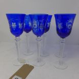 A collection of cobalt blue crystal wine glasses, decorated with flowers and grapes, (6)