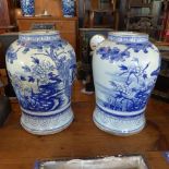 A pair of late 19th century blue and white porcelain temple jars, decorated with flowers and
