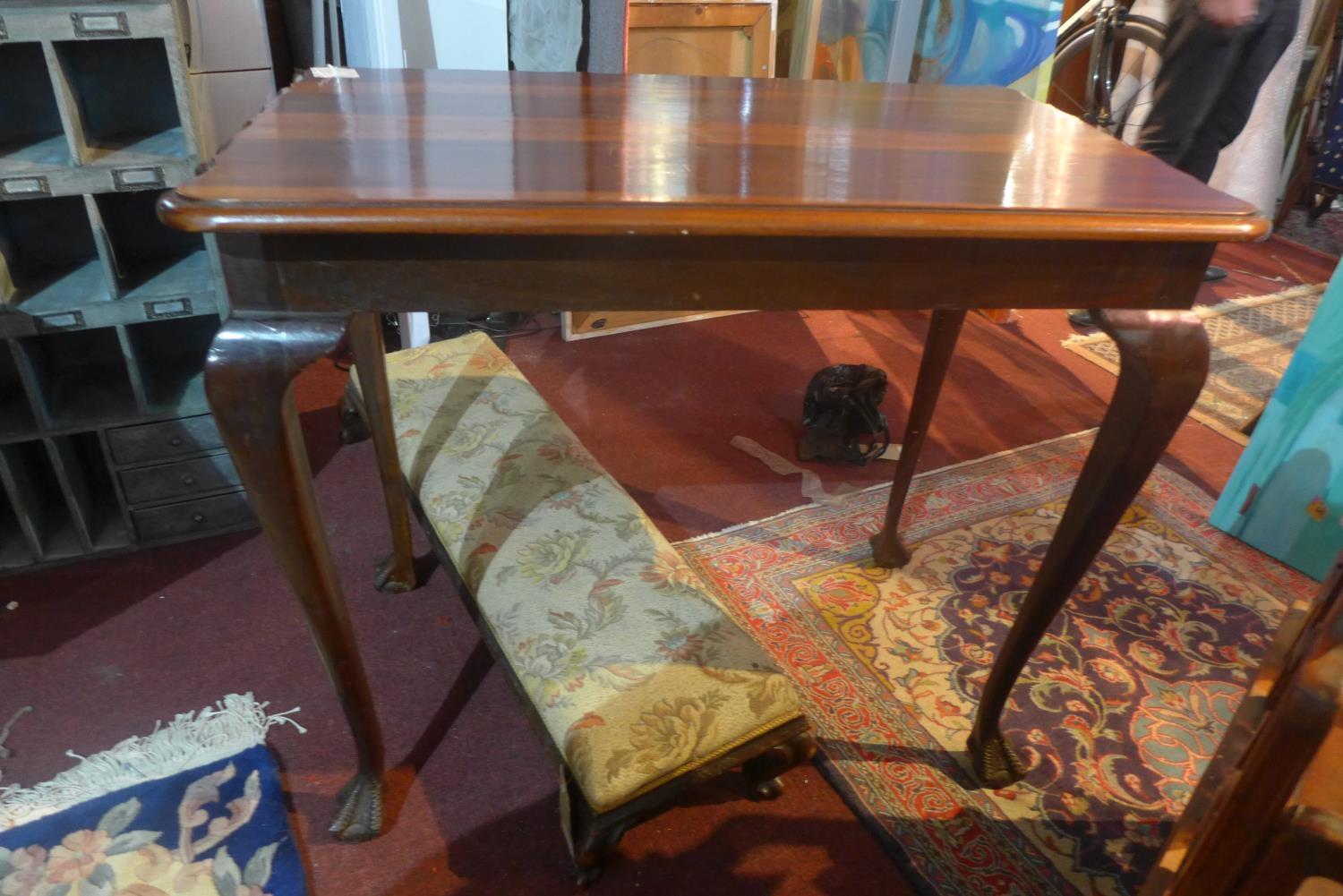 A 20th century mahogany centre table, raised on cabriole legs, H.77 W.91 D.55cm