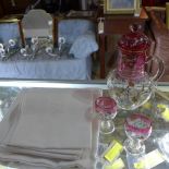 Six white linen napkins and a table cloth, monogrammed 'G.M', together with a glass jug and two