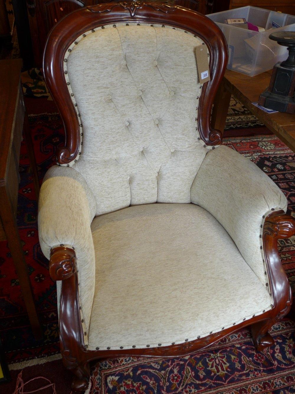 A pair of Victorian style mahogany spoon back armchairs, with cream button back upholstery, raised