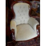 A pair of Victorian style mahogany spoon back armchairs, with cream button back upholstery, raised