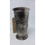 A Danish white metal beaker (possibly silver), repousse embossed with revellers listening to a