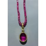 A tourmaline beaded necklace, with 18k yellow gold pendant inset with cushion cut tourmaline,