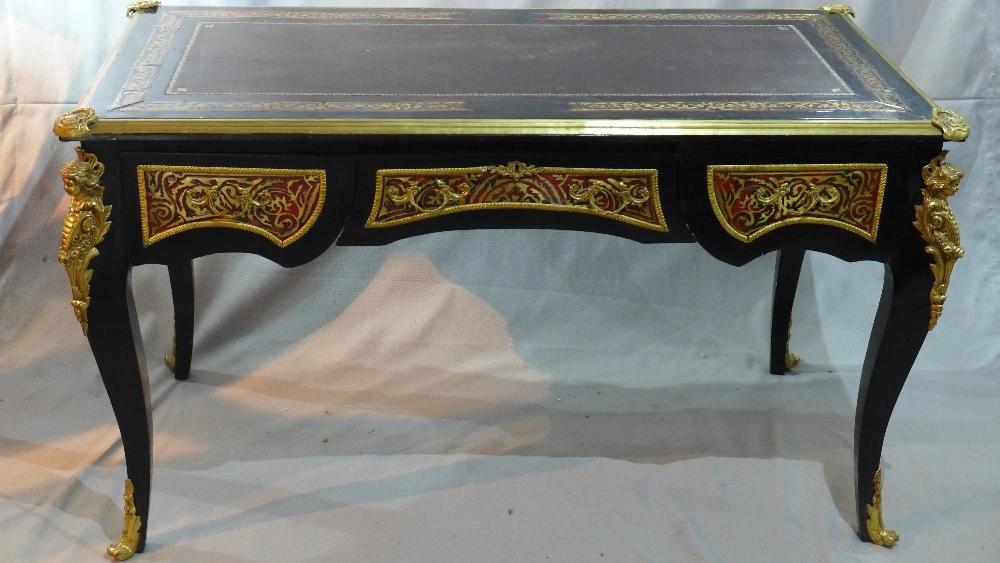 A Louis XV style ebonized boulle desk, having leather top, ormolu mounts, three drawers, raised on