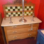 An Art Nouveau pine wash stand, with tiled superstructure over marble top and three long drawers,