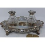 A Victorian silver inkwell, London 1863, makers mark HW, with pierced flower and scroll design,