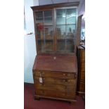 A Georgian mahogany bureau bookcase with two astragal glazed doors enclosing adjustable shelves