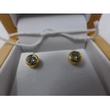 A pair of 18ct gold and diamond stud earrings, approx. combined carat 0.5