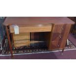 A mid 20th century Austinsuite desk, with four drawers, raised on brass feet, H.73 W.107 D.43cm