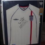 A framed and glazed signed England football shirt from 2001-2002