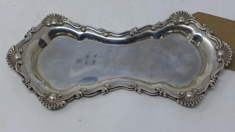 A Georgian silver snuffer tray, of waisted form with shell and scroll border, indistinctly