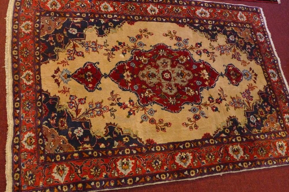 A fine North West Persian Sarouk rug, central double pendent medallion on a cream field within