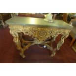 A mid 20th century Rococo style giltwood console table, having marble top on carved C-scroll legs