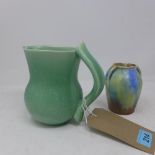 A twin handled art pottery vase, mottled design, H.11cm, together with a green glazed jug, C.H. &