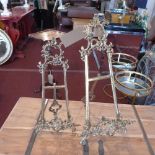 Two Rococo style gilt metal table top easels, H.69cm and H.53cm