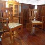 A set of six Arts & Crafts oak dining chairs, to include two carvers, the drop-in seats with William