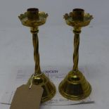 A pair of Victorian Gothic revival heavy brass candle sticks, bought from Liberty's with original