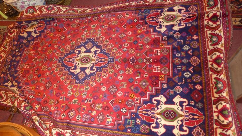 A fine South West Persian Afshar carpet, central diamond medallion with repeating petal motifs on