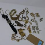 A collection of early 20th century jewellery to include a silver gilt bangle, a bracelet made from
