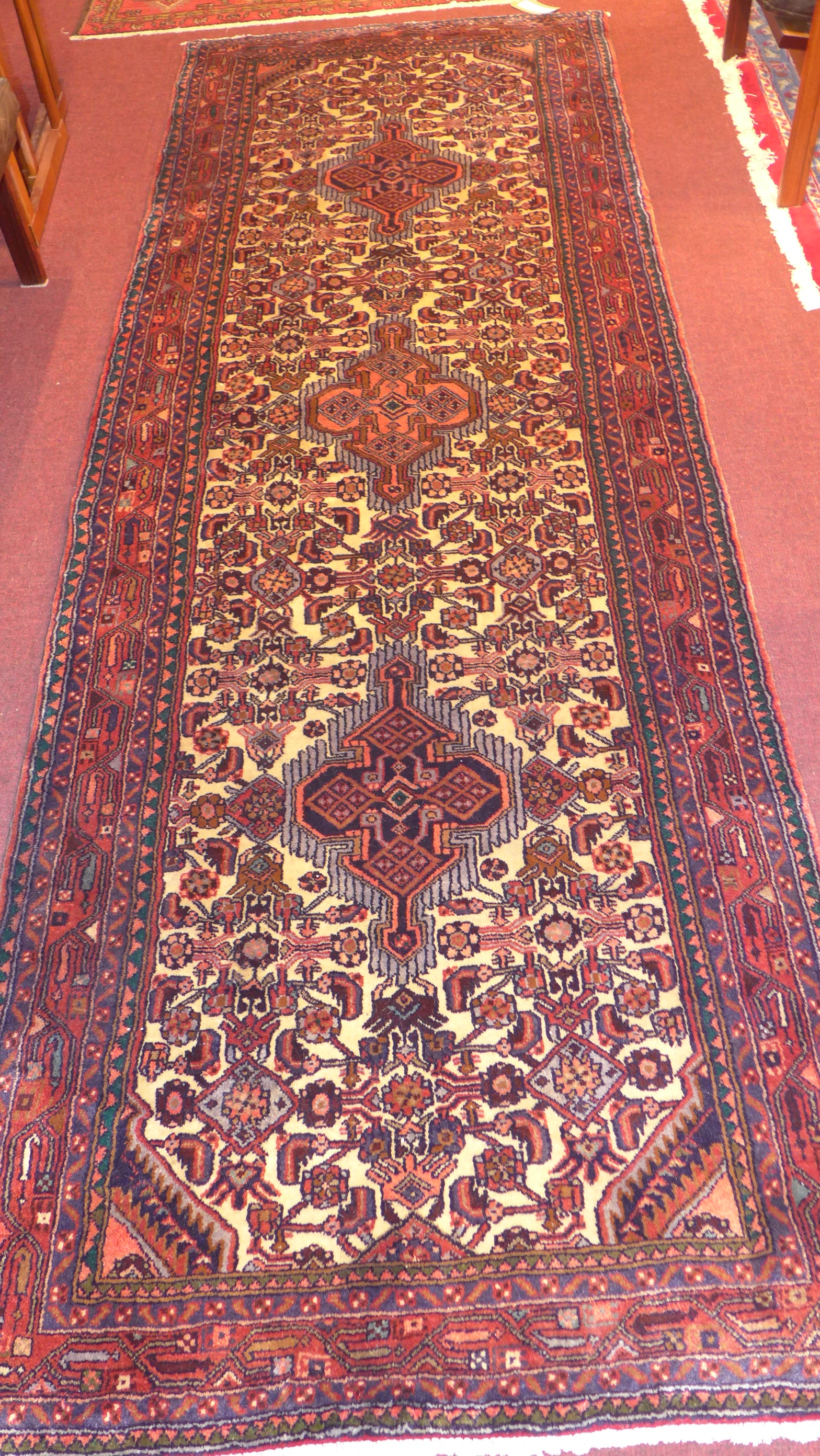 A North West Persian Malayer runner, triple pole medallion with repeating petal motifs on a cream